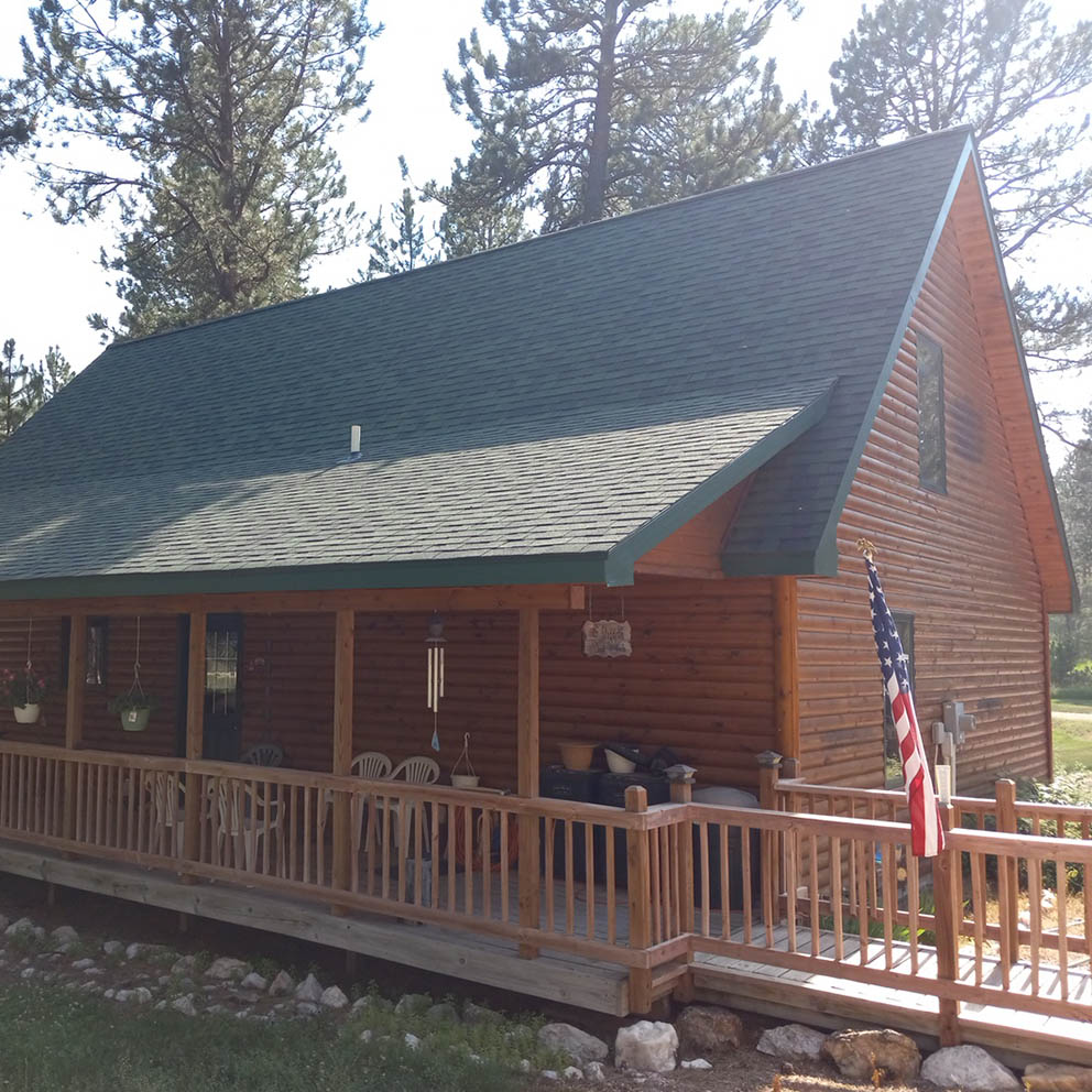 Photo of a new roof on an older cabin.